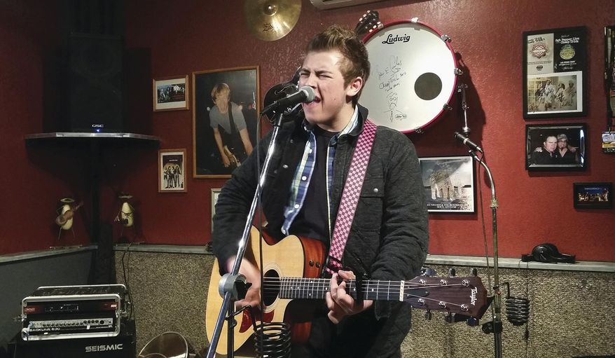 ADVANCE FOR USE SUNDAY, MAY 3 AND THEREAFTER - In this March 19, 2015, 2015 photo, Tristan "Tree" Bushman plays his song "Underdogs" in the practice space at his uncle's home in Dixon, Ill. The 17-year-old has come a long way since writing "a few bad songs" in eighth grade. Bushman hasn't yet graduated high school, but he's already playing as many shows in a year as many local musicians who are two or three times his age. (Alex T. Paschal/Sauk Valley Media via AP)