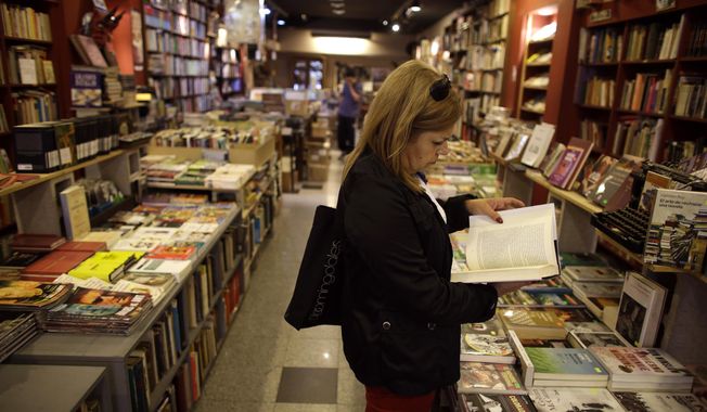 In this Tuesday, April 21, 2015, file photo, a customer reads a book at a bookstore in Buenos Aires, Argentina. (AP Photo/Victor R. Caivano, File)