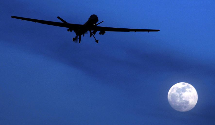 An unmanned U.S. Predator drone flies over Kandahar Air Field, southern Afghanistan in this Jan. 31, 2010, file photo. Nearly three-quarters of Americans say it’s acceptable for the U.S. to use unmanned aerial drones to kill an American citizen abroad if that person has joined a terror organization, according to a new Associated Press-GfK poll. (AP Photo/Kirsty Wigglesworth, File)