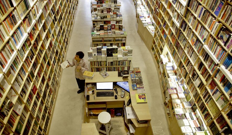 FILE - In this Tuesday, April 21, 2015, file photo, an employee works at a bookstore in Buenos Aires, Argentina. Buenos Aires is the city with more book shops per capita of any capital city in the world, according to a recent study released by the World Cities Culture Forum, a collaborative network of global cities with a focus on the importance of their cultural offerings. (AP Photo/Victor R. Caivano, File)