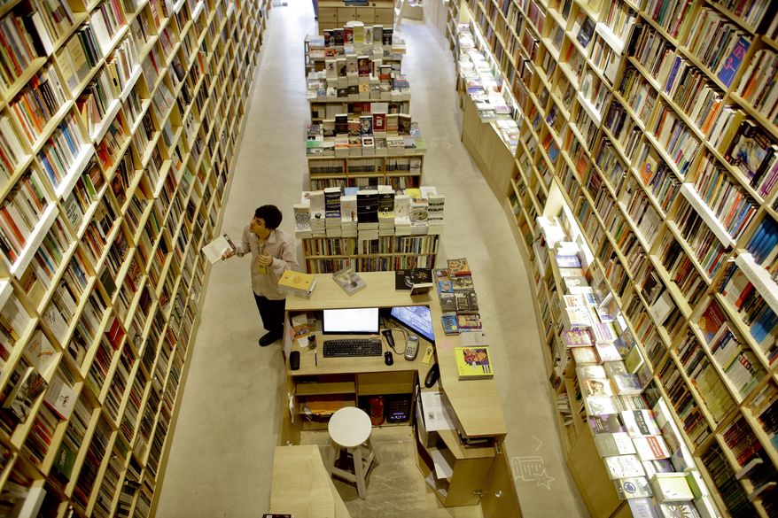 FILE - In this Tuesday, April 21, 2015, file photo, an employee works at a bookstore in Buenos Aires, Argentina. Buenos Aires is the city with more book shops per capita of any capital city in the world, according to a recent study released by the World Cities Culture Forum, a collaborative network of global cities with a focus on the importance of their cultural offerings. (AP Photo/Victor R. Caivano, File)