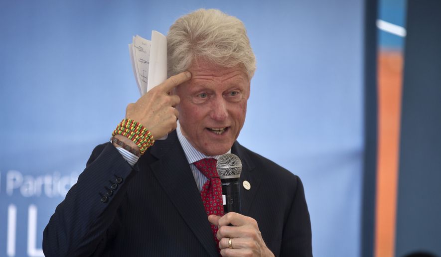 Former President Bill Clinton gestures while wearing a bracelet given to him by the pupils, as he and Chelsea Clinton talk about their foundation&#x27;s &quot;No Ceilings&quot; project about the participation of women and girls globally, at the Farasi Lane Primary School in Nairobi, Kenya Friday, May 1, 2015. Former President Bill Clinton and daughter Chelsea Clinton are in the East African nation of Kenya as part of a wider tour of projects run by the family&#x27;s Clinton Foundation. (AP Photo/Ben Curtis)