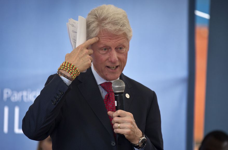 Former President Bill Clinton gestures while wearing a bracelet given to him by the pupils, as he and Chelsea Clinton talk about their foundation&#x27;s &quot;No Ceilings&quot; project about the participation of women and girls globally, at the Farasi Lane Primary School in Nairobi, Kenya Friday, May 1, 2015. Former President Bill Clinton and daughter Chelsea Clinton are in the East African nation of Kenya as part of a wider tour of projects run by the family&#x27;s Clinton Foundation. (AP Photo/Ben Curtis)