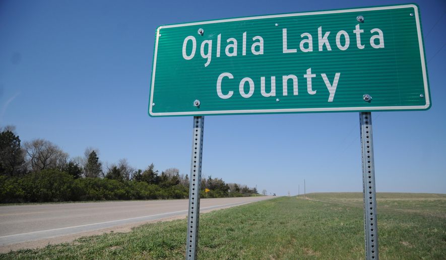 This April 29, 2015 photo shows a sign for the newly named Oglala Lakota County in Batesland, S.D. The name change will officially take effect on Friday. Shannon County has officially become Oglala Lakota County, scrubbing away the name of a man who Oglala Sioux Tribe activists say helped usher in a significant breakup of sovereign lands. (AP Photo/James Nord)