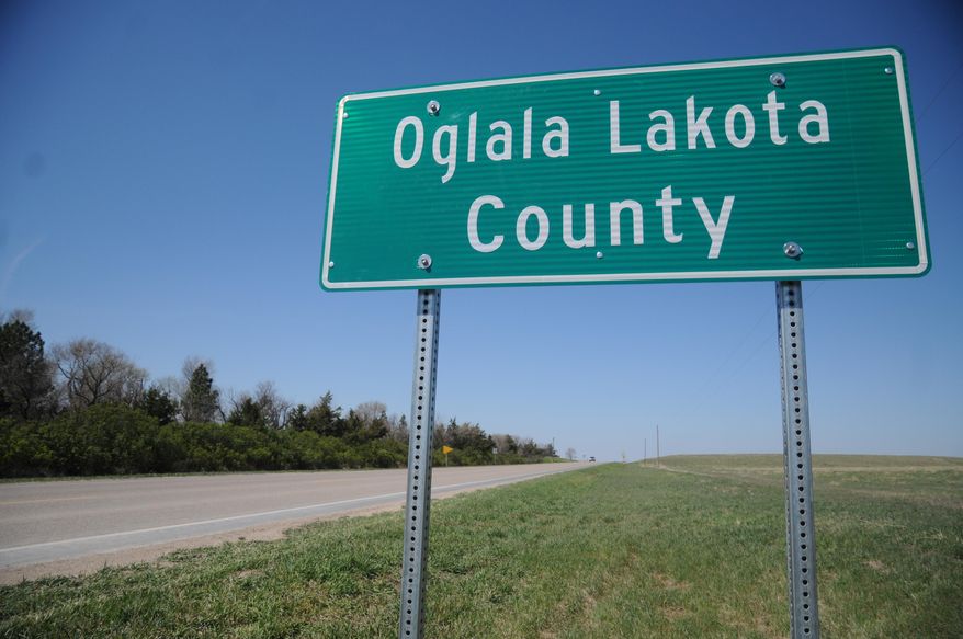 This April 29, 2015 photo shows a sign for the newly named Oglala Lakota County in Batesland, S.D. The name change will officially take effect on Friday. Shannon County has officially become Oglala Lakota County, scrubbing away the name of a man who Oglala Sioux Tribe activists say helped usher in a significant breakup of sovereign lands. (AP Photo/James Nord)