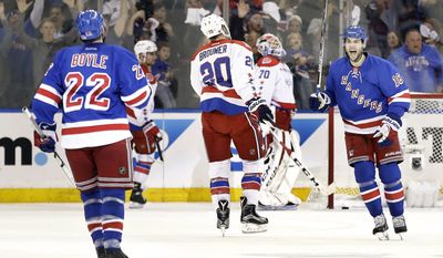 New York Rangers center Derick Brassard (16) celebrates with defenseman Dan Boyle (22) after Boyle score a goal on a power play against the Washington Capitals during the first period of Game 2 in the second round of the NHL Stanley Cup hockey playoffs Saturday, May 2, 2015, in New York. (AP Photo/Frank Franklin II)