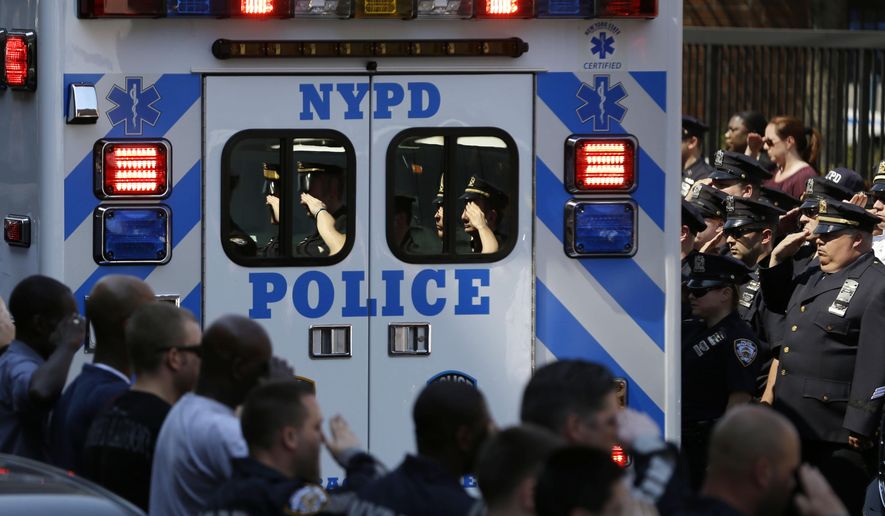 Police officers salute as the body of Brian Moore leaves Jamaica Hospital in New York, Monday, May 4, 2015. Moore, a 25-year-old police officer shot in the head over the weekend while attempting to stop a man suspected of carrying a handgun, has died from his injuries, the third New York Police Department officer slain in the line-of-duty in five months, a City Hall official said Monday. (AP Photo/Seth Wenig)