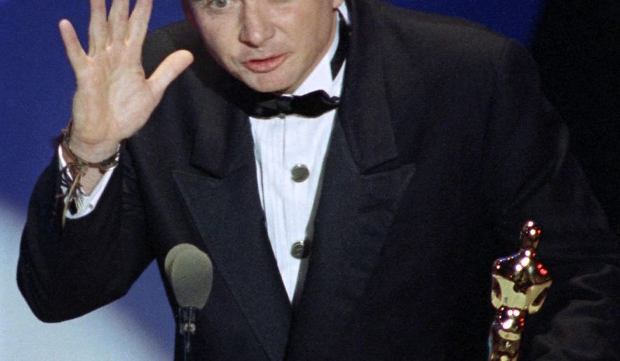 FILE - This March 26, 1991 file photo shows Michael Blake accepting the Oscar for best adapted screenplay for "Dances with Wolves" at the 63rd Annual Academy Awards in Los Angeles. Blake's business partner, Daniel Ostroff, says the 69-year-old died Saturday in Tucson, Ariz., after a long battle with cancer. (AP Photo/Reed Saxon, File)