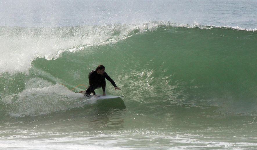 Big waves challenge surfers at Malibu, Calif., as a long-period, south swell moved into the Southern California Bight on Sunday, May 3, 2015. The National Weather Service said the swell, with a period of about 20 seconds, would translate to surf of 5 feet to 8 feet with local sets to 10 feet at favored south-facing beaches including Malibu. Beachgoers were warned to expect powerful rip currents. (AP Photo/John Antczak)