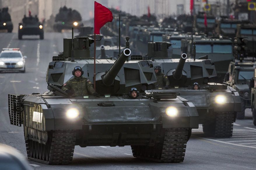 New Russian military vehicles including the new Russian T-14 Armata tank, foreground, make their way to Red Square during a rehearsal for the Victory Day military parade which will take place at Moscow&#39;s Red Square on May 9 to celebrate 70 years after the victory in WWII, in Moscow, Russia, Monday, May 4, 2015. Russia&#39;s new Armata tank has appeared in public for the first time, rumbling down a broad Moscow avenue on its way to Red Square for the Victory Day parade&#39;s final rehearsal. (AP Photo/Alexander Zemlianichenko)