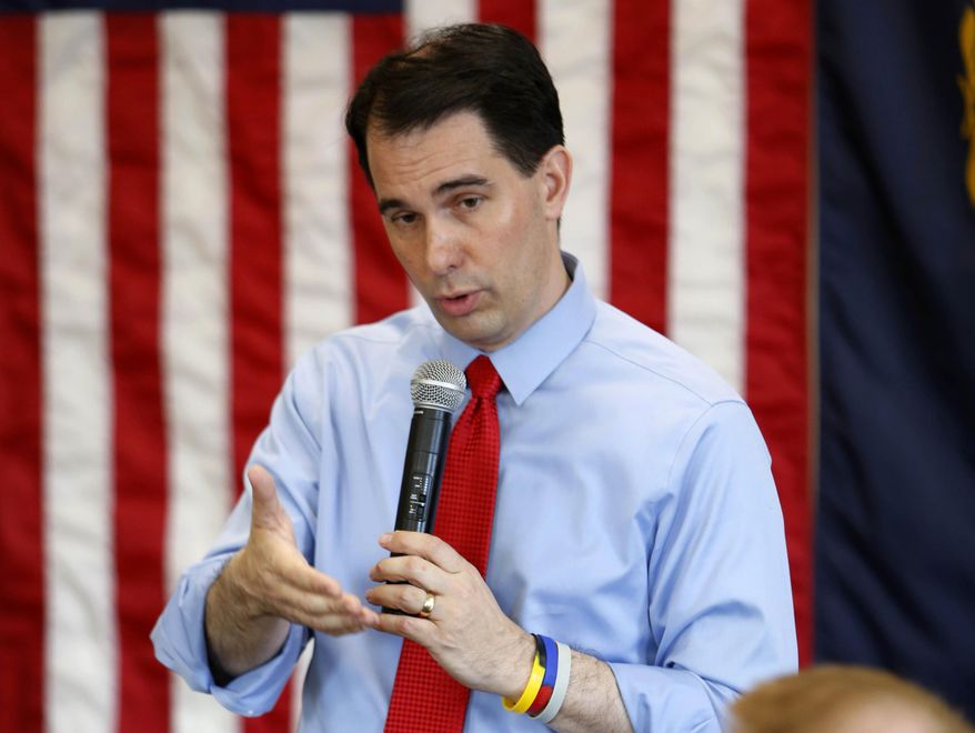 FILE - In this April 19, 2015 file photo, Wisconsin Gov. Scott Walker speaks in Derry, N.H. Walker has emerged as a force in the 2016 White House contest. It's a position two other Republican governors from the Midwest, lesser known but similarly ambitious, undoubtedly would like to be in. (AP Photo/Jim Cole, File)