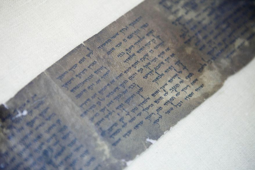 This Friday, May 10, 2013, file photo shows the world's oldest complete copy of the Ten Commandments, written on one of the Dead Sea Scrolls in Jerusalem. The manuscript is on rare display at Israel's national museum in an exhibit of objects from pivotal moments in the history of civilization. (AP Photo/Dan Balilty, File)