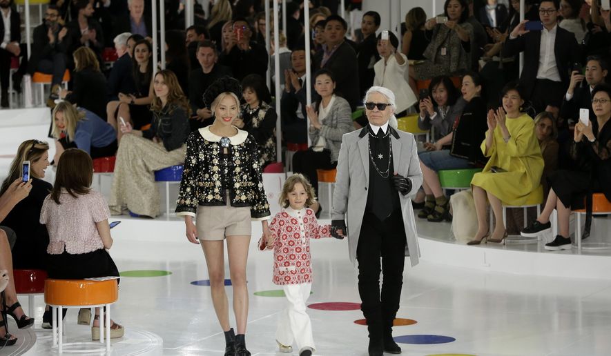 German fashion designer Karl Lagerfeld, right, walks the runway with models after the presentation of his 2015-2016 Chanel cruise collection at the Dongdaemun Design Plaza in Seoul, South Korea, Monday, May 4, 2015. (AP Photo/Ahn Young-joon)