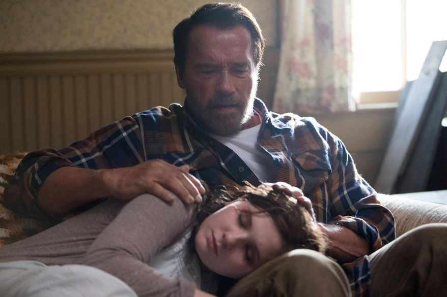 In this image released by Roadside Attractions, Abigail Breslin, foreground, and Arnold Schwarzenegger appear in a scene from "Maggie." (Tracy Bennett/Roadside Attractions via AP)