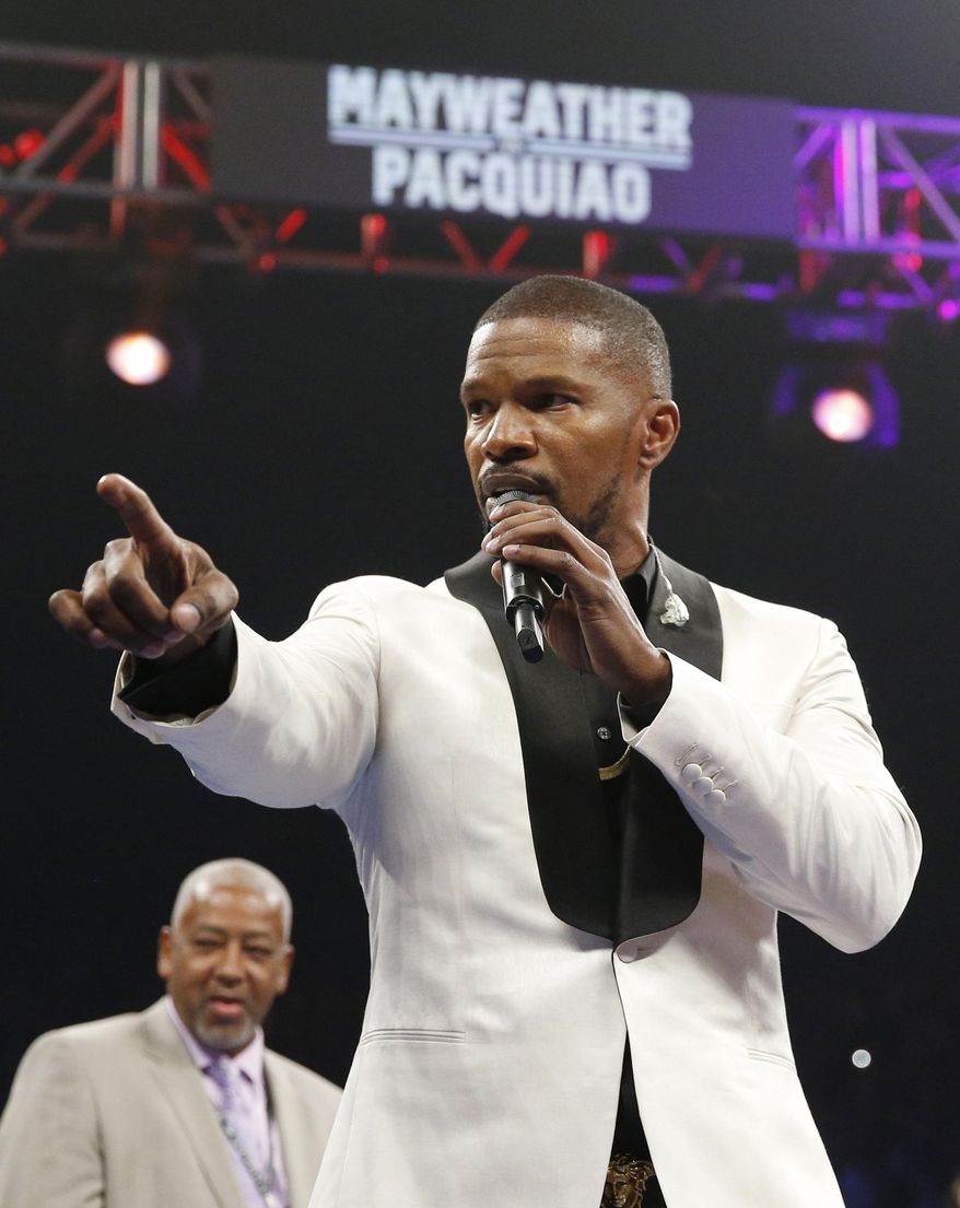 In this May 2, 2015, file photo, actor Jamie Foxx sings the national anthem before the start of the world welterweight championship bout between Floyd Mayweather Jr. and Manny Pacquiao in Las Vegas. (AP Photo/Isaac Brekken, File)