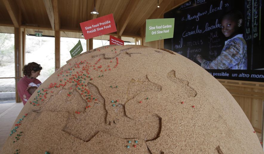 In this photo taken on Saturday, May 2, 2015, people visit the Slow Food pavilion at the Expo 2015 in Rho, near Milan, Italy. At Milan Expo 2015, it’s still an analog world, after all. Undoubtedly, the overarching theme of food, nutrition and sustainability at the Milan world’s fair, which opened May 1 for a six-month run, guarantees a tactile, sensory and even culinary experience that by definition is more real than virtual even in this social media-fueled era. Yes, technology is employed for every manner of awe-inspiring immersive and interactive experience, and anyone with a smart phone can download a gaggle of apps meant to enhance and organize visits to the site itself and to the individual pavilions. (AP Photo/Antonio Calanni)