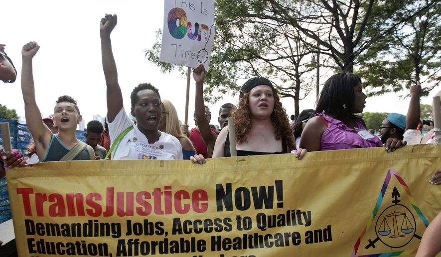 In this June 27, 2014, file photo, people march during the 10th annual Trans Day of Action in New York. (AP Photo/Frank Franklin II, File)