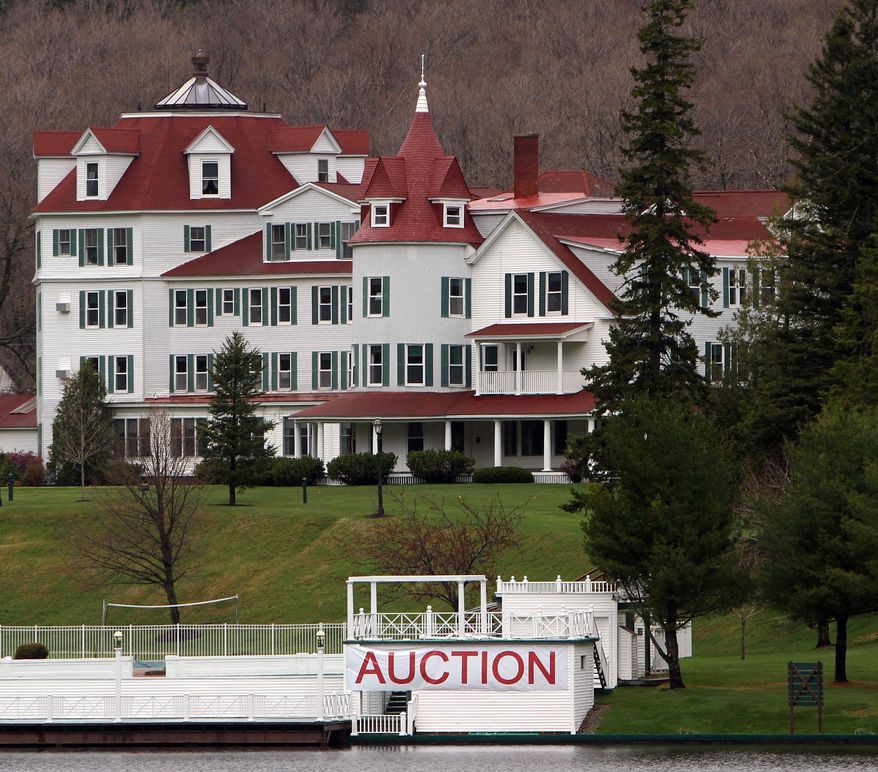 FILE - In this May 10, 2012, file photo, a large sign hangs in front of the Balsams Hotel in Dixeville Notch, N.H., where an auction was scheduled to clear out the nearly 150-year-old resort. A bill to pave the way for an ambitious plan to restore the resort got the go-ahead from New Hampshire's House of Representatives Wednesday, May 6, 2015. The bill would create a special taxing district allowing the state to back $28 million in bonds toward redeveloping the Balsams, which closed in 2011. (AP Photo/Jim Cole, File)