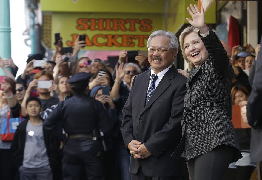 Democratic presidential candidate Hillary Rodham Clinton, right, waves next to San Francisco Mayor Ed Lee after visiting Red Blossom Tea Company in Chinatown in San Francisco, Wednesday, May 6, 2015. (AP Photo/Jeff Chiu)