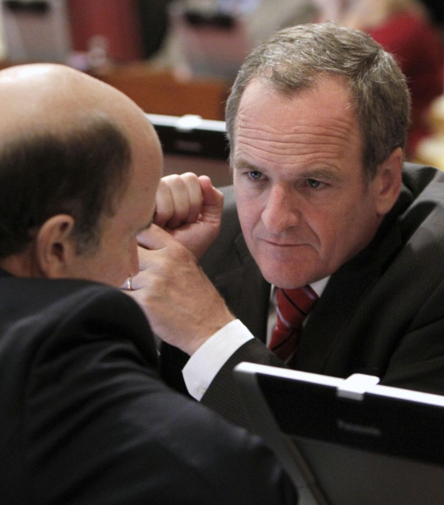 FILE - In this Aug. 30, 2012 file photo, Republican state Sen. Sam Blakeslee, of San Luis Obisp, right, confers with Sen. Mark Wyland, R- Solana Beach, at the Capitol in Sacramento, Calif. Blakeslee and Lt. Gov. Gavin Newsom have teamed up with computer scientists at Cal Poly San Luis Obispo on a web-based video search engine that they hope will democratize government by using the latest in voice- and face-recognition software to allow people to see, hear and read what their representatives are doing in the state capital. (AP Photo/Rich Pedroncelli, File)