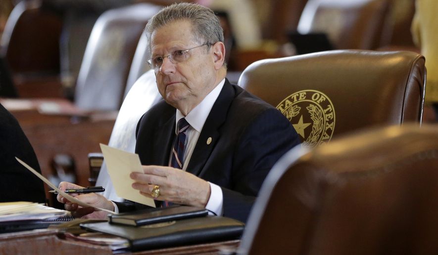 In this May 5, 2015 photo, Texas Rep. Rick Miller, R-Sugar Land, works in the House Chamber, Tuesday in Austin, Texas. Miller has filed a bill that would repeal local ordinances that ban discrimination against gay and transgender people _ attempting to roll back rules passed in many large Texas cities. The propose bill puts Miller at odds with his son, Beau Miller, who is an HIV-positive gay activist. (AP Photo/Eric Gay)