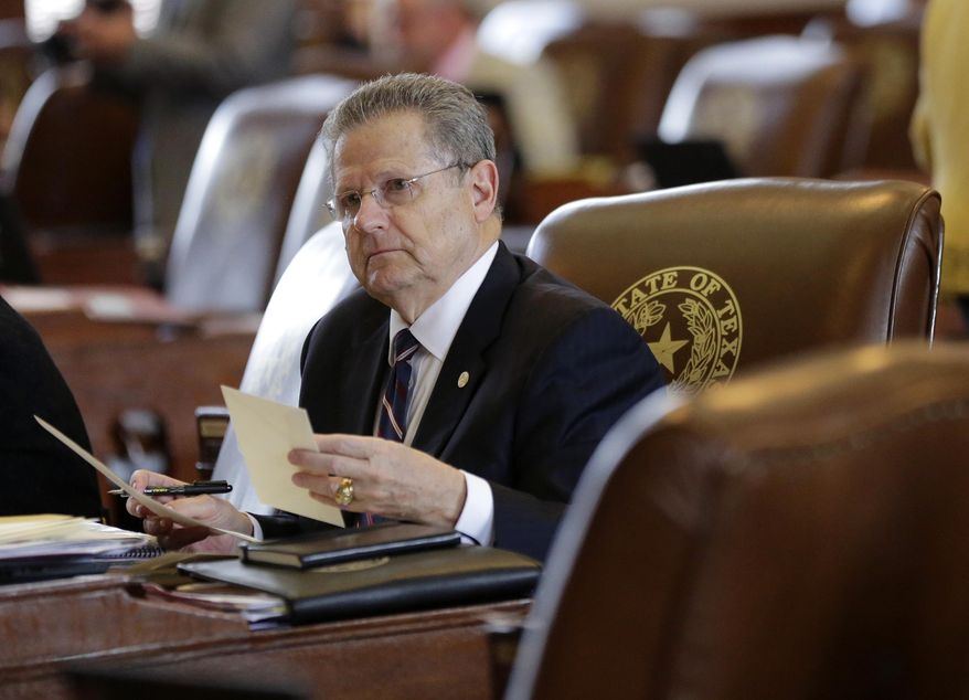 In this May 5, 2015 photo, Texas Rep. Rick Miller, R-Sugar Land, works in the House Chamber, Tuesday in Austin, Texas. Miller has filed a bill that would repeal local ordinances that ban discrimination against gay and transgender people _ attempting to roll back rules passed in many large Texas cities. The propose bill puts Miller at odds with his son, Beau Miller, who is an HIV-positive gay activist. (AP Photo/Eric Gay)