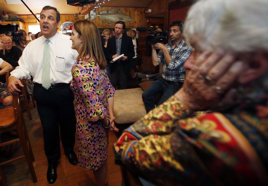 Barbara McGuiness, right, listens as possible 2016 presidential candidate Republican New Jersey Gov. Chris Christie speaks at the One Mile West restaurant Thursday, May 7, 2015, in Sunapee, N.H. (AP Photo/Jim Cole)