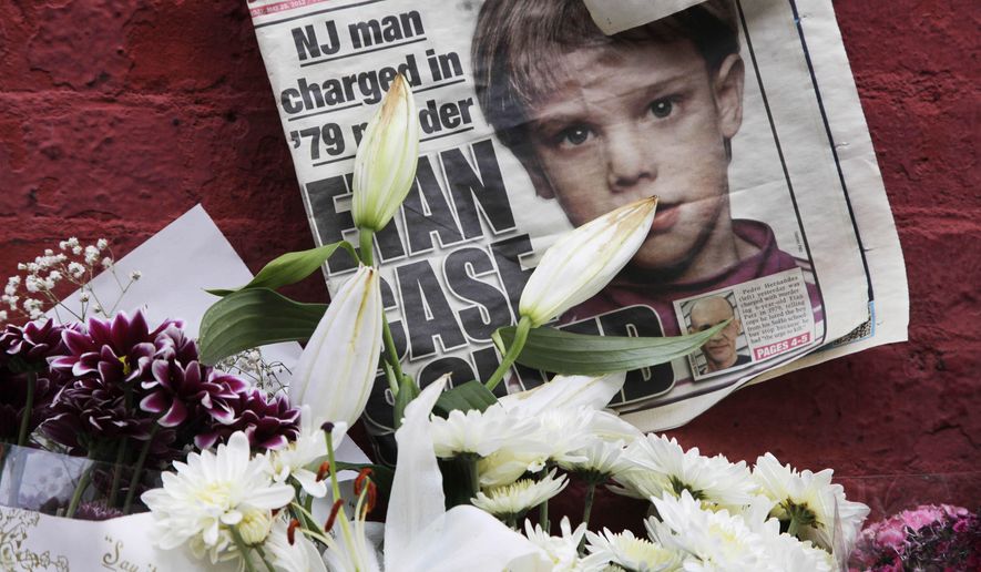 FILE - This May 28, 2012, file photo shows a newspaper with a photograph of Etan Patz at a makeshift memorial in the SoHo neighborhood of New York where Patz lived before his disappearance on May 25, 1979. The murder trial of Pedro Hernandez, the man accused in the child’s disappearance, ended Friday, May 8, 2015 with the jury hopelessly deadlocked after 18 days of deliberations, leaving unresolved a case that has haunted New York City for 36 years. (AP Photo/Mark Lennihan, File)