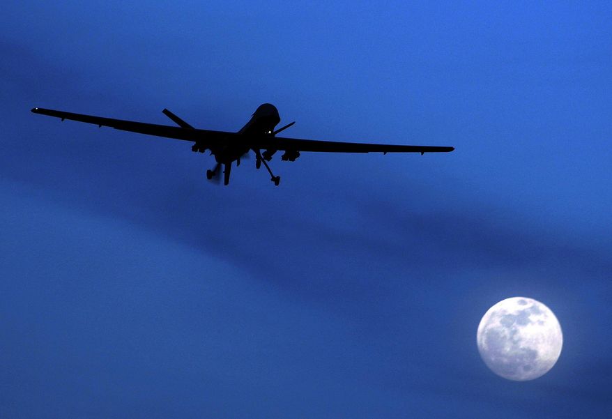 FILE - In this Jan. 31, 2010 file photo, an unmanned U.S. Predator drone flies over Kandahar Air Field, southern Afghanistan, on a moon-lit night. The deaths of an Italian and an American in a covert CIA drone strike in Pakistan have breathed new urgency into a long-stalled plan to give the Pentagon primacy over targeted killing of terrorists overseas. (AP Photo/Kirsty Wigglesworth, File)