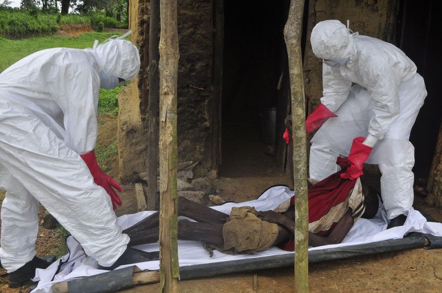 FILE-In this Friday, Oct. 31, 2014 file photo, health workers carry the body of a old man from his house, with the Ebola virus being the suspected cause of death, in the Siah Town area on the outskirts of Monrovia, Liberia. Liberia is now free of Ebola after going 42 days _ twice the maximum incubation period for the deadly disease _ without any new cases, the World Health Organization announced on Saturday, May 9, 2015. (AP Photo/ Abbas Dulleh, File)