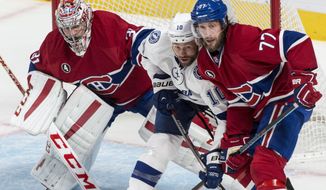 Montreal Canadiens goalie Carey Price, left, tries to look past Tampa Bay Lightning&#39;s Brenden Morrow and Canadiens defenseman Tom Gilbert during the second period of Game 5 of a second-round NHL Stanley Cup hockey playoff series Saturday, May 9, 2015, in Montreal. (Paul Chiasson/The Canadian Press via AP) MANDATORY CREDIT