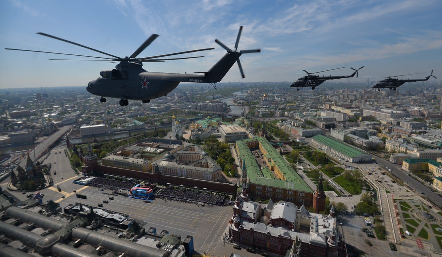 A Russian air force Mi-26 helicopter, front, flies over Red Square during the Victory Parade marking the 70th anniversary of the defeat of the Nazis in World War II, in Red Square in Moscow, Russia, Saturday, May 9, 2015. (Host photo agency/RIA Novosti Pool Photo via AP) ** FILE **