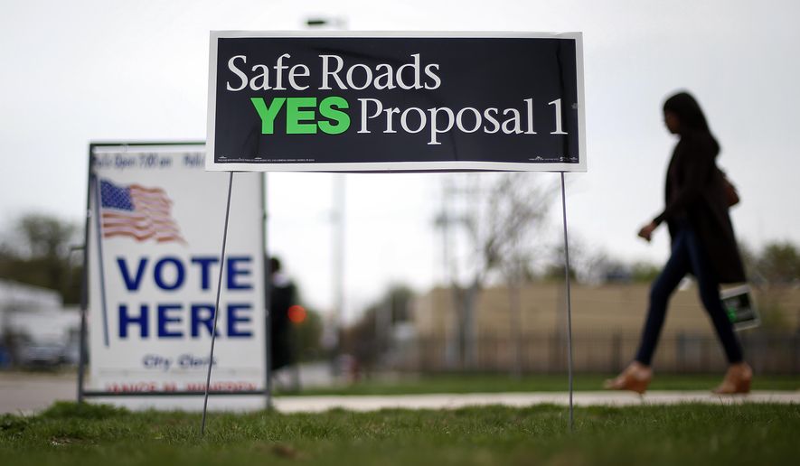FILE - In this May 5, 2015 file photo, a voter leaves a polling location in Detroit. Voters sent a clear message to Gov. Rick Snyder and lawmakers after crushing a ballot measure that would have pumped $1.2 billion more a year into deteriorating roads and bridges: you must do better. Legislators are still processing how to proceed, but Proposal 1's defeat gave advocates of increased transportation spending some ideas of what not to do. (AP Photo/Paul Sancya)