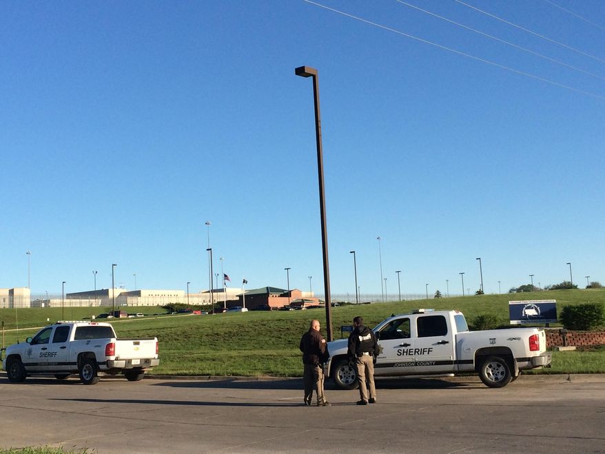 Members of the Johnson County Sheriff's Department stand outside the the Tecumseh State Correctional Institution Monday, May 11, 2015, in Tecomseh, Neb. Inmates at the maximum security prison in southeastern Nebraska have taken control of at least part of the facility in an incident that left two staff members and two prisoners injured, according to the state Department of Correctional Services. The incident started around 2:30 p.m. Sunday at the Tecumseh State Correctional Institution when staff members attempted to break up a large gathering of inmates in front of a housing unit, James Foster, a department spokesman, said in a statement. There was no indication early Monday that authorities have resumed full control at the facility that houses 11 death row inmates, and there were no reports of any escapes. (AP Photo/Anna Gronewold)