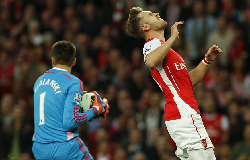 Arsenal&#39;s Aaron Ramsey, right, misses a chance to score a goal during their English Premier League soccer match between Arsenal and Swansea City at the Emirates stadium in London, Monday May 11, 2015. (AP Photo/Alastair Grant)