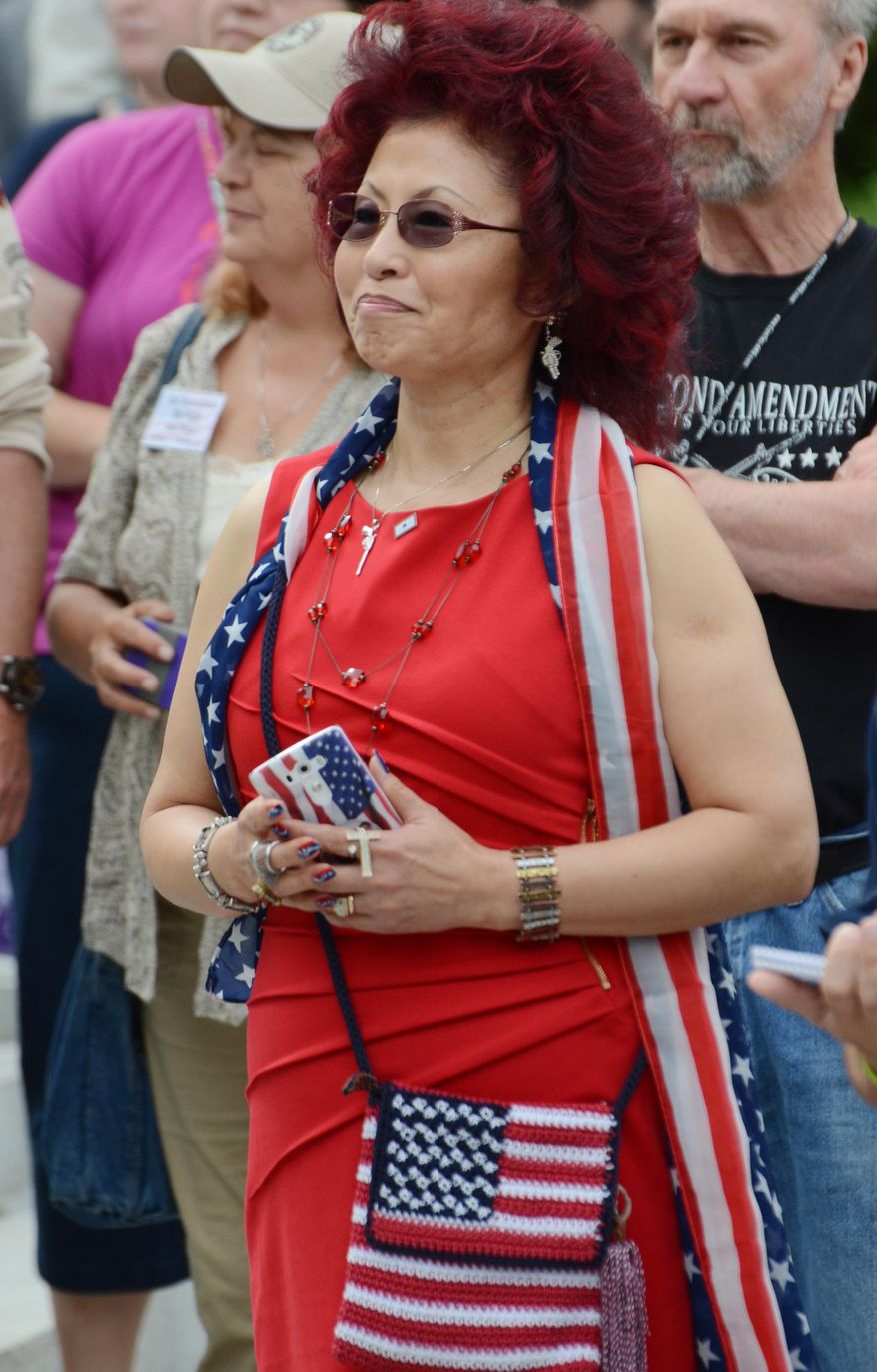 Yong Saccone of Elizabeth, Pa., attends the 10th annual Second Amendment Action Day rally on the steps of the Pennsylvania Capitol on Tuesday, May 12, 2015, in Harrisburg, Pa. Her husband, state Rep. Rick Saccone, R-Allegheny, spoke at the event. A few hundred gun rights activists brought their message to what has become an annual event at the state Capitol, urging lawmakers on Tuesday to protect their right to keep and own firearms and to widen legal protections. (AP Photo/Marc Levy)