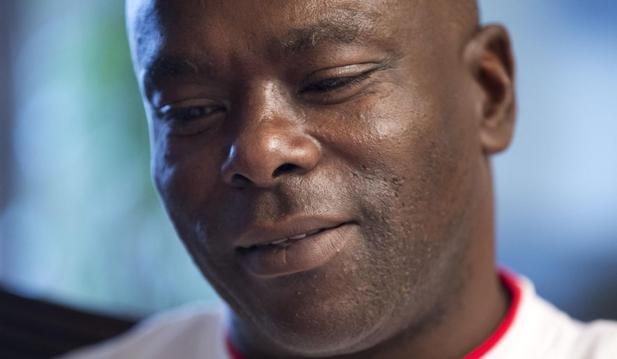 In this photo taken April 30, 2015, Kirk Odom speaks to The Associated Press at his home in southeast in Washington, Thursday, April 30, 2015. Odom was convicted of a 1981 rape and robbery after a woman identified him as her attacker and an FBI specialist testified that hair on her nightgown was consistent with hair on Odom’s head. But DNA testing some 30 years later affirmed what Odom long had maintained: The hair wasn’t his, nor was the semen left on a pillowcase and robe. A felony conviction that imprisoned him for decades was overturned in 2012 by a judge who declared it a “grave miscarriage of justice.” (AP Photo/Manuel Balce Ceneta)