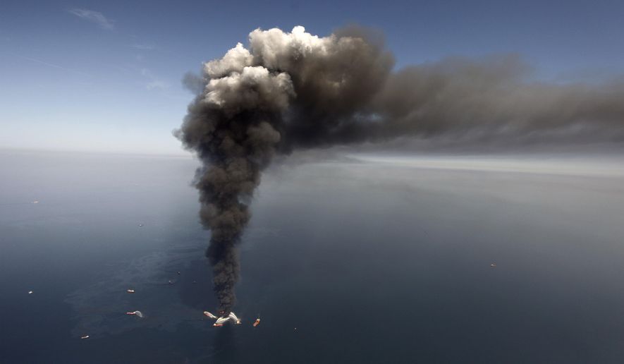FILE - In this April 2010 file photo, oil can be seen in the Gulf of Mexico, more than 50 miles southeast of Venice on Louisiana's tip, as a large plume of smoke rises from fires on BP's Deepwater Horizon offshore oil rig. Deep-water drilling is set to resume near the site of the catastrophic BP PLC well blowout that killed 11 workers and caused the nation's largest offshore oil spill five years ago off the coast of Louisiana. (AP Photo/Gerald Herbert, File)
