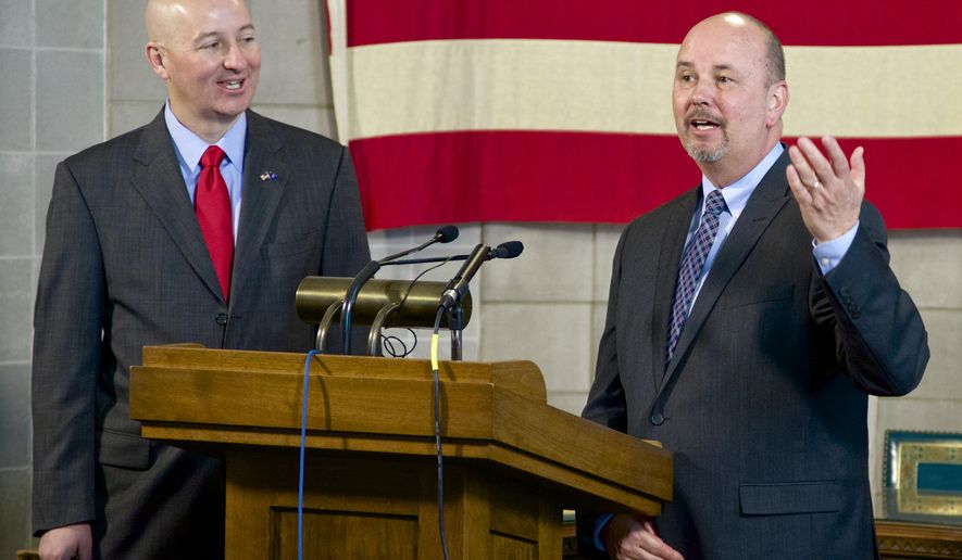 Neb. Gov. Pete Ricketts, left, listens to Scott Frakes, director of the Nebraska Department of Corrections, during a news conference in Lincoln, Neb., Tuesday, May 12, 2015, as they discuss the aftermath of the weekend prison disturbance that left two inmates dead at the Tecumseh State Correctional Institution, a maximum security prison in southeast Nebraska. The Tecumseh State Correctional Institution remained on lockdown Tuesday, Frakes says the situation was under control. (AP Photo/Nati Harnik)