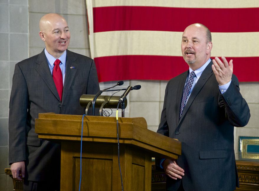 Neb. Gov. Pete Ricketts, left, listens to Scott Frakes, director of the Nebraska Department of Corrections, during a news conference in Lincoln, Neb., Tuesday, May 12, 2015, as they discuss the aftermath of the weekend prison disturbance that left two inmates dead at the Tecumseh State Correctional Institution, a maximum security prison in southeast Nebraska. The Tecumseh State Correctional Institution remained on lockdown Tuesday, Frakes says the situation was under control. (AP Photo/Nati Harnik)
