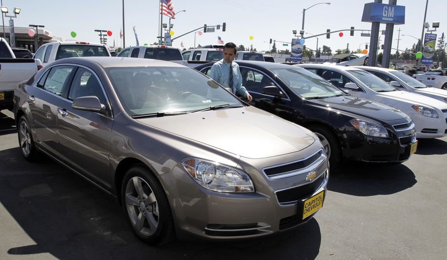 FILE - In this Aug. 30, 2011 file photo, 2011 Chevrolet Malibus are lined up at a car dealership in San Jose, Calif. General Motors is recalling nearly 470,000 Chevrolet Malibu midsize cars from the 2011 and 2012 model years to fix potentially weakened steel cables that link the front seat belts to the vehicles. (AP Photo/Paul Sakuma, File)
