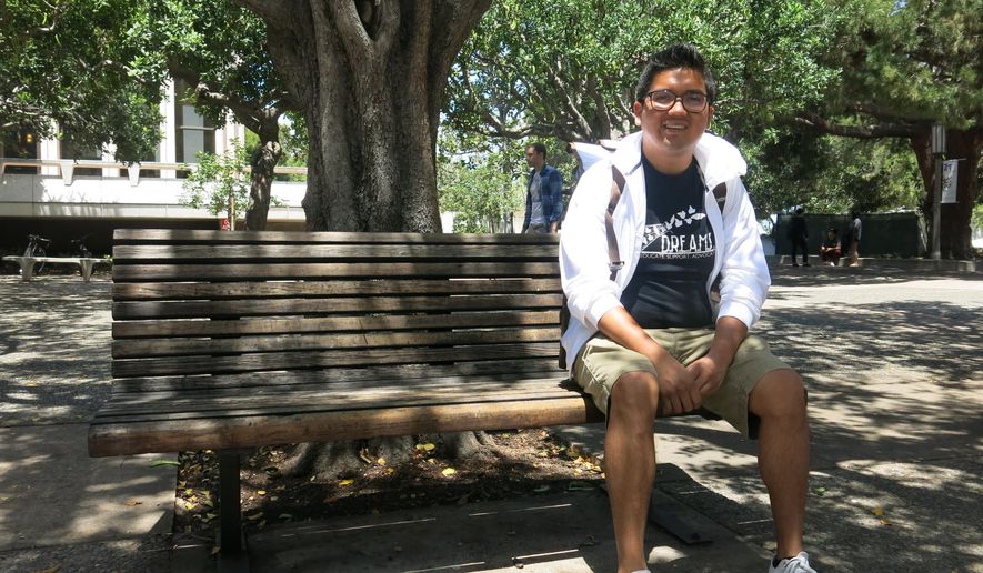 Rene Amel Peralta, 28, a chemistry student at University of California, Irvine, poses for a photo at the university, Tuesday, May 12, 2015. Peralta, who arrived in the U.S. at age 13 and only speaking Spanish, says he now uses more English than Spanish as he pursues his college degree. A report by Pew Research Center found a rising share of Hispanics in the United States speak proficient English while the percentage of those speaking Spanish at home has been declining. (AP Photo/Amy Taxin)