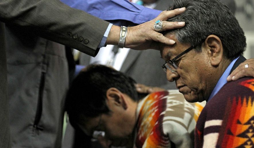 Navajo Nation Vice President Jonathan Nez, left, and Navajo Nation President Russell Begaye receive blessings during their inauguration ceremony at Fighting Scouts Events Center in Fort Defiance, Ariz., Tuesday, May 12, 2015. Begaye easily beat former two-term President Joe Shirley Jr. in a special election last month for the post on the country's largest American Indian reservation. (Alexa Rogals/The Daily Times via AP)