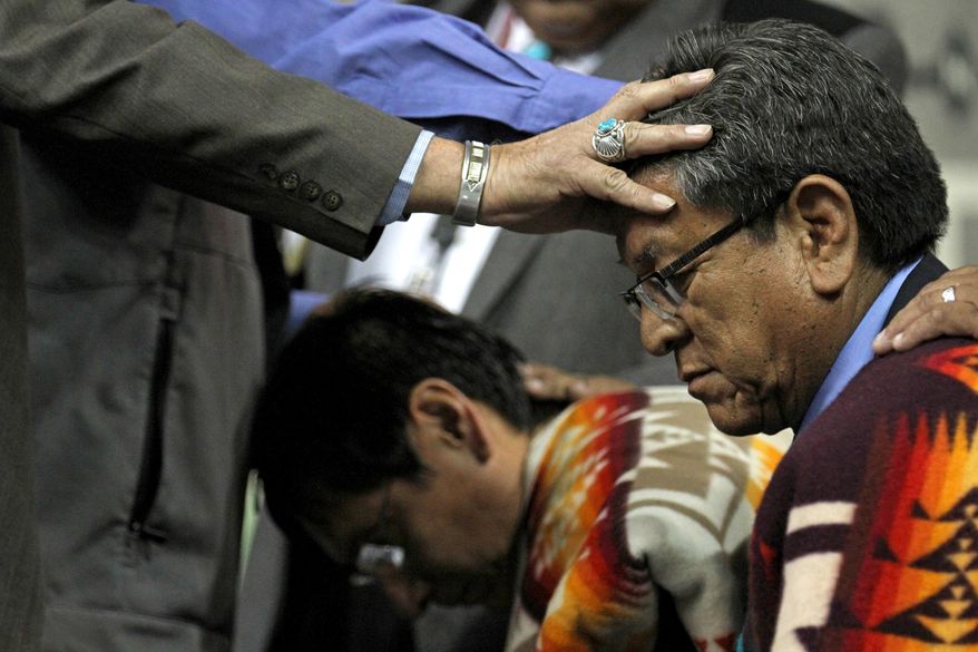 Navajo Nation Vice President Jonathan Nez, left, and Navajo Nation President Russell Begaye receive blessings during their inauguration ceremony at Fighting Scouts Events Center in Fort Defiance, Ariz., Tuesday, May 12, 2015. Begaye easily beat former two-term President Joe Shirley Jr. in a special election last month for the post on the country's largest American Indian reservation. (Alexa Rogals/The Daily Times via AP)