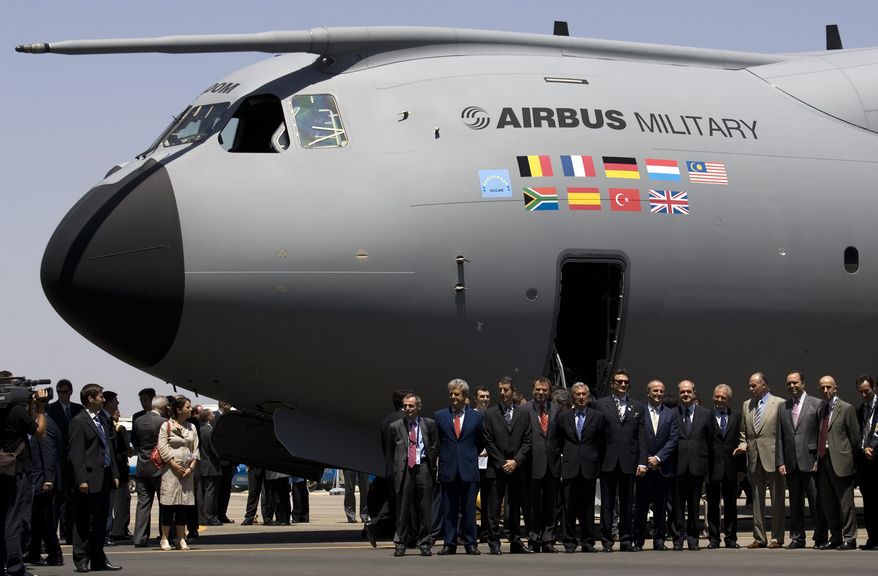 FILE - In this June 26, 2008 file photo, Spanish King Juan Carlos, fourth from right, poses with other officials in front of the new military Airbus A400M in Seville, Spain. Investors pushed Airbus shares down Monday May 11, 2015 on Paris&#39; stock exchange after an Airbus military transport plane undergoing final flight testing in Spain crashed, killing four aboard and injuring two. Airbus shares were down 4.3 percent to 60.67 euros ($67.88) as authorities investigated what caused the A400M to crash into a farm field Saturday after taking off from Seville, where the planes are assembled.(AP Photo/Victor R. Caivano, File)