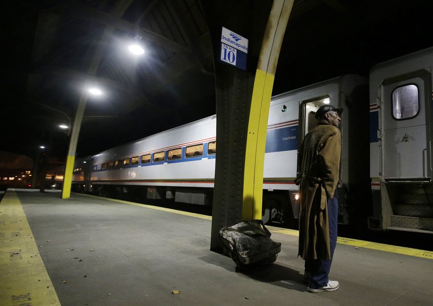 In this Dec. 16, 2014 photo Benny Funderburk waits to board the Amtrak train bound for Chicago out of Union Station in downtown Indianapolis. The Hoosier State is the least-traveled of Amtrak’s routes, with just under 34,000 passengers in fiscal year 2014. It is also the only short-haul Amtrak route still in search of a long-term funding deal after Congress shifted most of the costs of those lines from the federal government to the states. Riders who enjoy rail travel or rely on the train because they don’t drive say they don’t want to see the service end. But much will depend on whether the state can find a way to pay for it that doesn’t break the bank. (AP Photo/Darron Cummings)