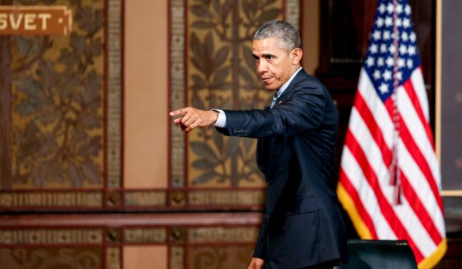 President Obama points to the audience as he departs after speaking at the Catholic-Evangelical Leadership Summit on Overcoming Poverty at Gaston Hall at Georgetown University in Washington on May 12, 2015. (Associated Press)