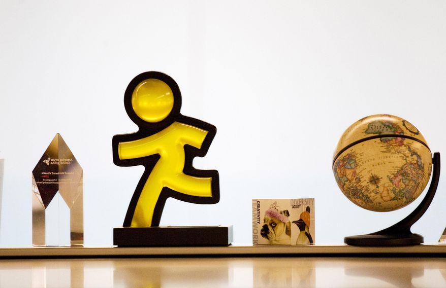 FILE - This May 12, 2008 file photo shows the AOL Running Man logo and other decorations at AOL's New York offices. Verizon on Tuesday, May 12, 2015 announced it is buying AOL for about $4.4 billion, advancing the telecom's push in both mobile and advertising fields. (AP Photo/Mark Lennihan, File)