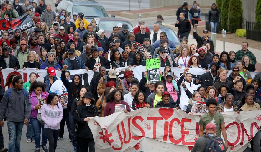 Supporters of Tony Robinson's family participate in a march along E. Wilson St., Tuesday, May 12, 2015, in Madison, Wisc. Dane County District Attorney Ismael Ozanne announced Tuesday that Madison Police Officer Matt Kenny would not face charges for the shooting death of Robinson. (John Hart/Wisconsin State Journal via AP)