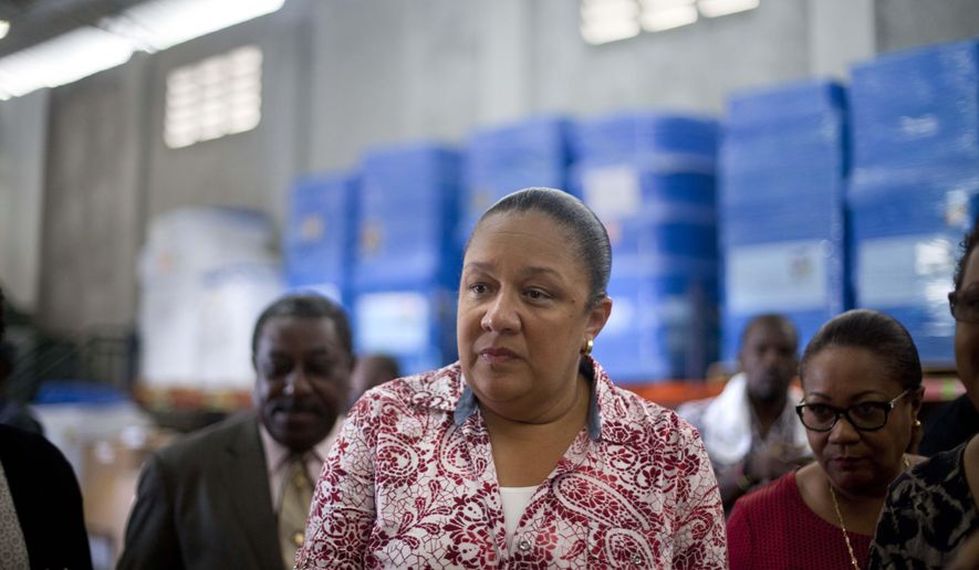 FILE - In this Sept. 10, 2014, file photo, Haiti's first lady Sophia Martelly visits a warehouse housing a donation of kits to treat chikungunya, in the Cite Soleil slum, in Port-au-Prince, Haiti. An elections committee in Haiti has the rejected first lady's bid to run for Senate. Electoral council spokesman Richardson Dumel said Wednesday, May 13, 2015, that the committee would not allow the wife of President Michel Martelly to pursue her candidacy. He did not provide details about the decision. (AP Photo/Dieu Nalio Chery, File)